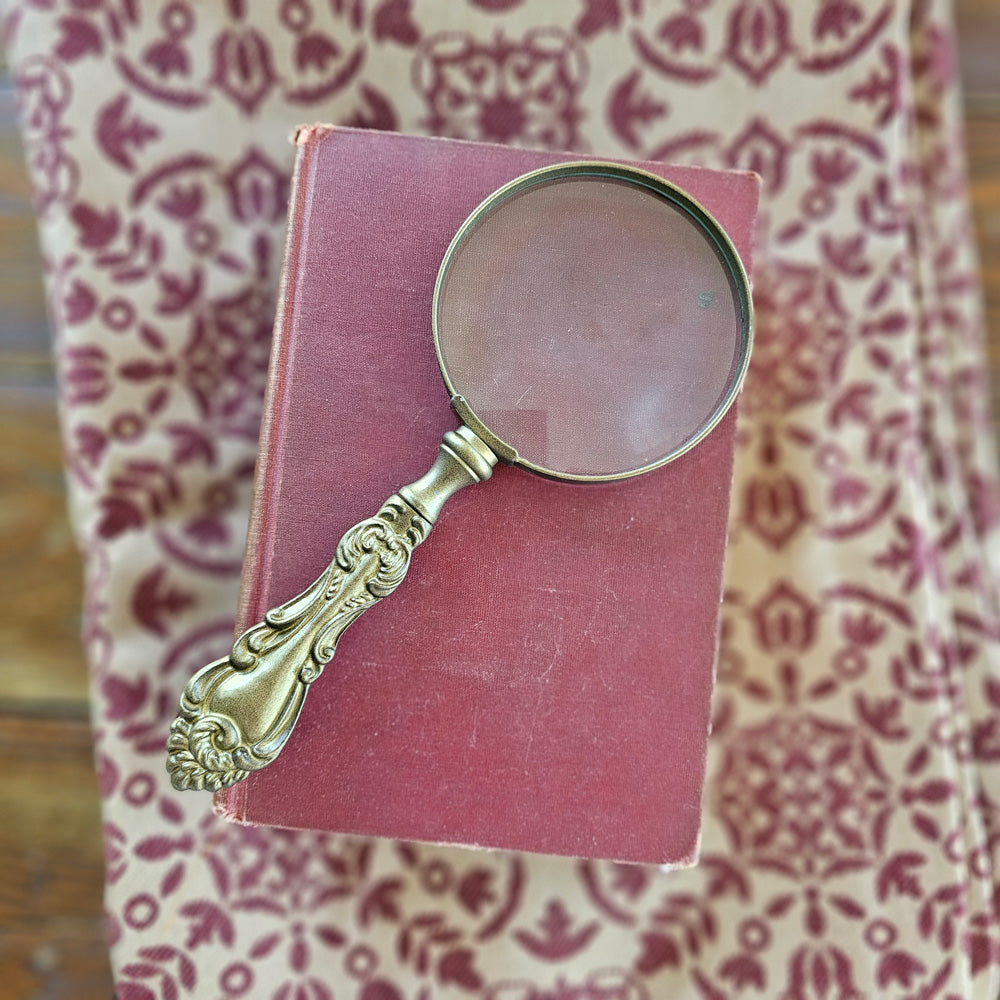 You won't miss the fine print with this Brass Finish Magnifying Glass. It is the perfect little helper.  The handle features an intricate vintage design. Great for a vintage style home office. 3.5"W x 8.5"H