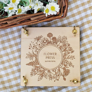 Transform flowers into lasting works of art with our Flower Press Kit. Made of high-quality wood with a delicate floral design, it's perfect for pressing flowers and displaying them as beautiful decor pieces. Its compact size makes it easy to take on hikes for on-the-go flower pressing. The natural wooden press has brass hardware. Each press comes assembled and ready to use. Each press is 4.75" X 4.75" 