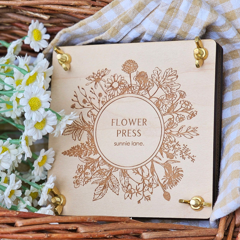 Transform flowers into lasting works of art with our Flower Press Kit. Made of high-quality wood with a delicate floral design, it's perfect for pressing flowers and displaying them as beautiful decor pieces. Its compact size makes it easy to take on hikes for on-the-go flower pressing. The natural wooden press has brass hardware. Each press comes assembled and ready to use. Each press is 4.75" X 4.75" 