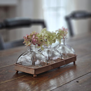 You’re going to fall in love with this old pharmacy inspired set!  Includes three glass bottles along with a copper style tray. These sweet bottles make perfect bud vases, allowing small flowers and herbs to be displayed with ease, which makes this set perfect for creating charming centerpiece designs.