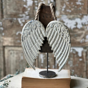 These Hanging Embossed Metal Wings are crafted with aged, embossed metal, giving them a vintage and elegant feel. The versatility allows for endless decorating options, whether they're nestled in a wreath or displayed on its own. Wreath not included.
