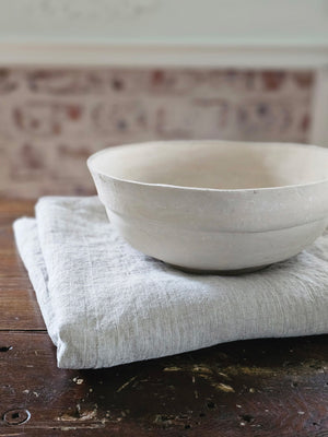 This White Farmhouse Paper Mache Bowl Set has a primitive, organic look, making them an easy fit for both modern and vintage farmhouses. Each large white bowl has a hand-crafted, timeless feel and a chalky white finish. The set includes three large sturdy bowls, perfect for adding a minimal farmhouse touch to any tabletop. For decorative use only. Set of three. 