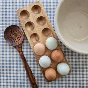 Inspired by antique egg holders, such as ones spotted in the Downton Abbey kitchen,  our farmhouse Wood Egg Tray will be right at home in your kitchen. It makes a great accent for any shelf or countertop. The rustic wood egg crate holds 12 eggs. Eggs not included.