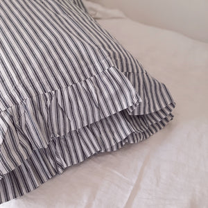 Add a cozy and refreshing look to your farmhouse style bedroom with the Chatham Blue Ticking Stripe and Ruffles Pillow Case Set of 2. Classic ticking stripes offer versatile style and can evoke a feeling of cool ocean breezes, vintage cottage vibes, or rustic romance. This Americana pillow case set features popular ticking stripes in denim blue and antique white with super soft 100% cotton material you'll enjoy for years to come. 
