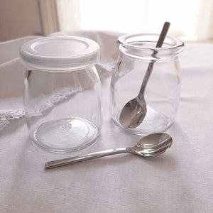 Our French Yogurt Jars and Demitasse Spoon Set inspires a new way to look at canning, dessert making and more. Perfect for jams, jellies, homemade baby food, parfaits, pudding treats and mini pies…the uses are endless.  The set includes two glass French Yogurt Jars, two Lids for airtight freshness, and two Stainless Steel Demitasse Spoons with sleek, minimalist style