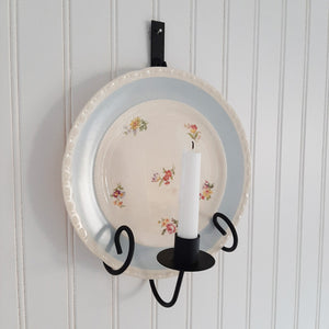 Instead of keeping those beautiful vintage dishes stashed away, put them on display with our Taper Candle Sconce and Plate Holder. This vintage style metal dish display makes it easy to show off your favorite floral plates. Use a vintage style mirror to create a warm glowing reflection with the candle. The primitive design of this wall mounted plate rack with candle holder is inspired by colonial candle plates and fits right in to farmhouse style decor.