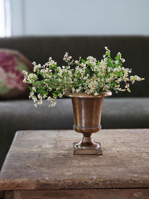 The Aged Bronze Gold Metal Urn Vase adds antique style to any tabletop. It features an old-world look with a timelessly aged feel. Crafted from metal, this vase is perfect for decorating any living space. 