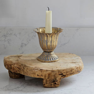 Our Aged Gold Fluted Urn Taper Candle Cup features a distressed gold metal finish with an ornate scalloped design. The cup sits on a pedestal and has plenty of space between the holder and the sides, making it the perfect choice for displaying a candle ring! The candle cup has vintage style and is ideal for catching dripping wax. Measures 3.75" in diameter and 4"H and holds a standard taper (candle not included).