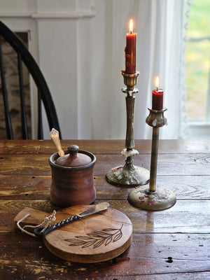 This Aged Brass Finish Taper Candle Holder Set brings timeless style to any tabletop. The old brass style finish has a time-worn patina, inspired by antique shop finds. This set of two features different style necks, both with a slender, elegant design. 