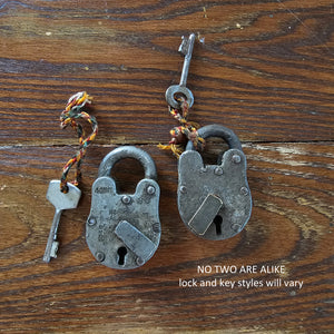 Our Antique Lock and Key adds the perfect vintage touch. Made of metal, these authentic antique lock and keys are each one-of-a-kind, so styles will vary. Pieces are attached via knotted multicolored rope for added appeal. Hang from an old cupboard door or use to create vintage vignettes. Dimensions are approximately 1.75"L x .50"W x 3.5"H  Item not eligible for return
