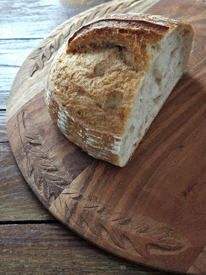 Bring the warmth and character of aged wood into your home with our Antique Style Wood Bread Board. Made of acacia wood, this serving board features beautiful hand-carved leaf designs around the edges. They make a beautiful and functional accent piece for any home. They can be used as a serving board,charcuterie board, cutting board, trivet, and more