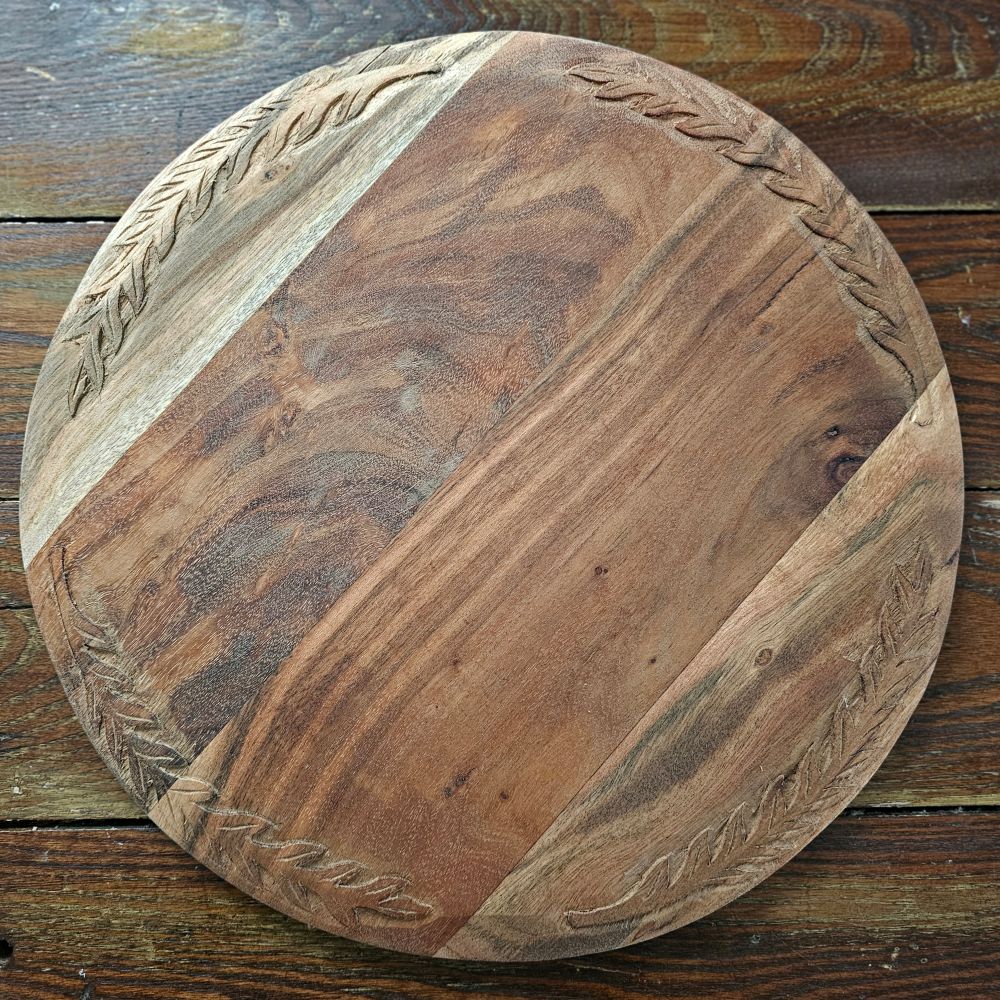 Bring the warmth and character of aged wood into your home with our Antique Style Wood Bread Board. Made of acacia wood, this serving board features beautiful hand-carved leaf designs around the edges. They make a beautiful and functional accent piece for any home. They can be used as a serving board,charcuterie board, cutting board, trivet, and more