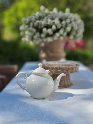 Add a romantic cottage touch with our Antique White Keepsake Teapot with Pierced Lace Trim. Made of fine porcelain, with delicate cut details along the rim, this teapot brings a dreamy elegance to any occasion. The antique white glaze fits well with creamware collections. 