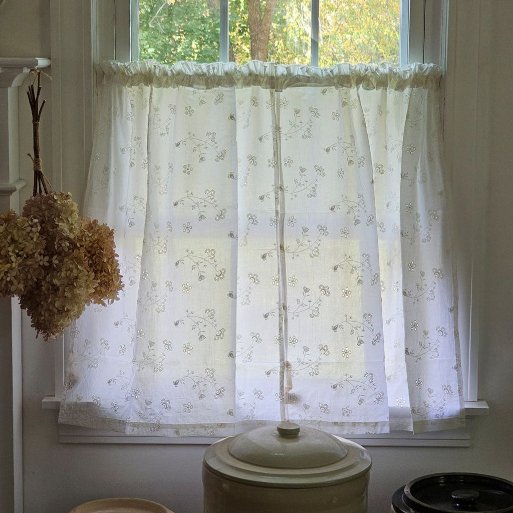Dress up any window in breezy cottage charm with the Antique White Lace Cafe Curtains. With a creamy, off-white cotton, this semi-sheer curtain tier set features a floral eyelet and embroidered pattern of little sprigs to update your home decor with a lighthearted country feel. Whether you're going for a coastal, cottage our country look, these cafe curtains add the perfect combination of simplicity and elegance 