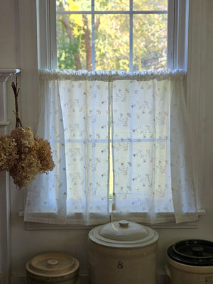 Dress up any window in breezy cottage charm with the Antique White Lace Cafe Curtains. With a creamy, off-white cotton, this semi-sheer curtain tier set features a floral eyelet and embroidered pattern of little sprigs to update your home decor with a lighthearted country feel. Whether you're going for a coastal, cottage our country look, these cafe curtains add the perfect combination of simplicity and elegance 
