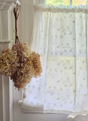 Dress up any window in breezy cottage charm with the Antique White Lace Cafe Curtains. With a creamy, off-white cotton, this semi-sheer curtain tier set features a floral eyelet and embroidered pattern of little sprigs to update your home decor with a lighthearted country feel. Whether you're going for a coastal, cottage our country look, these cafe curtains add the perfect combination of simplicity and elegance 