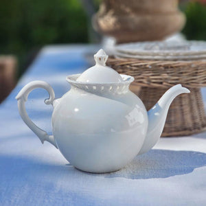Add a romantic cottage touch with our Antique White Keepsake Teapot with Pierced Lace Trim. Made of fine porcelain, with delicate cut details along the rim, this teapot brings a dreamy elegance to any occasion. The antique white glaze fits well with creamware collections. 