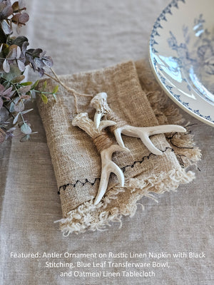 This rustic Antler Ornament features two resin antlers, hand wrapped in twine, creating a unique and down-to-earth look. Hang from your Christmas tree or use year-round as a woodland accent. 2.25"W x 4.25"H