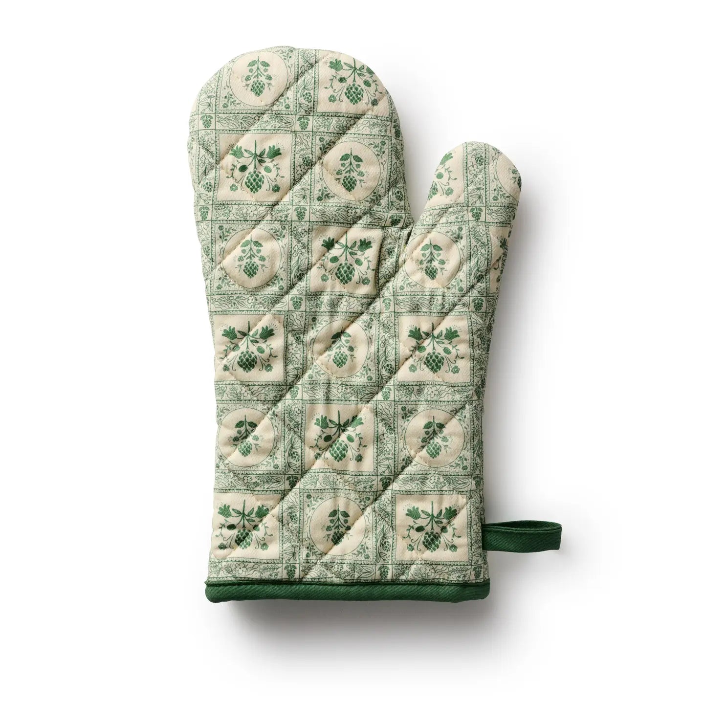 Bring timeless cottage elegance to your kitchen with the Artichoke Oven Mitt. Showcasing a vintage-inspired green artichoke motif against an ivory backdrop, it is accented with contrasting piping and a convenient corner loop for easy hanging. This quilted mitt offers reliable heat protection while enhancing your kitchen decor with refined charm. 100% cotton with polyester batting.