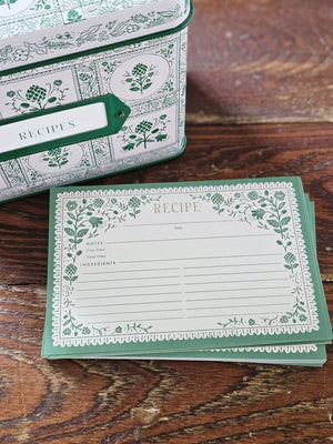 Keep treasured family recipes close at hand with the Artichoke Recipe Box. This vintage style tin recipe box brings cottage charm to your kitchen with its retro green artichoke design set against a creamy ivory background. It includes 24 beautifully illustrated recipe cards and coordinating recipe dividers. It holds up to 200 recipe cards. 6.5"L x 4.6'W x 5"H