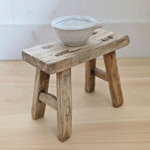 The Baby Elm Wood Stool is crafted from mid-1800's elm wood, a wood that is strong and long lasting and made without using nails or screws. These primitive pieces were created for pure function. Each features a perfectly imperfect rough-cut look with cracks and crevices that give this stool old-world charm and timeworn texture. Place accents such as vases, jars, candles or use to display small plants.