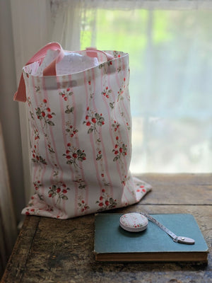 The Bespoke Strawberries and Stripes Tote Bag is perfect for groceries, shopping excursions at the farmers market or a day at the beach. This cotton canvas tote features a vintage-inspired strawberry design with sweet pink stripes and a pink handle. Made in England, the bespoke design is created with a love of color, heritage and intricate design while celebrating craftsmanship, storytelling and a strong sense of seasonality.