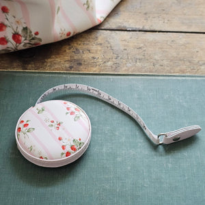 The Bespoke Strawberries and Stripes Travel Tape Measure is a handy little tool to keep on your desk or stash away in your purse for trips to the flea market. This faux leather compact tape measure features a vintage-inspired strawberry design with sweet pink stripes.