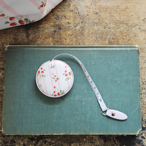 The Bespoke Strawberries and Stripes Travel Tape Measure is a handy little tool to keep on your desk or stash away in your purse for trips to the flea market. This faux leather compact tape measure features a vintage-inspired strawberry design with sweet pink stripes.