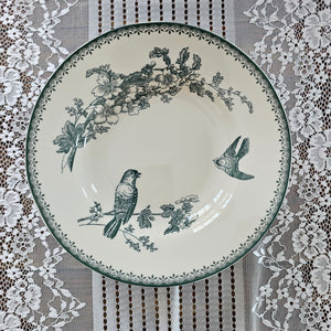 Inspired by antique transferware, our porcelain blue/green Bird Transferware Soup Bowl lends vintage cottage style to any shelf, tabletop or dinnerware collection. A vintage classic, transferware has adorned the shelves of American farmhouses for centuries. The delicate floral pattern in hunter green on an antique white background. Perfect for soups and salads. Food safe. Hand wash recommended. Includes one bowl. 8.88" Diam