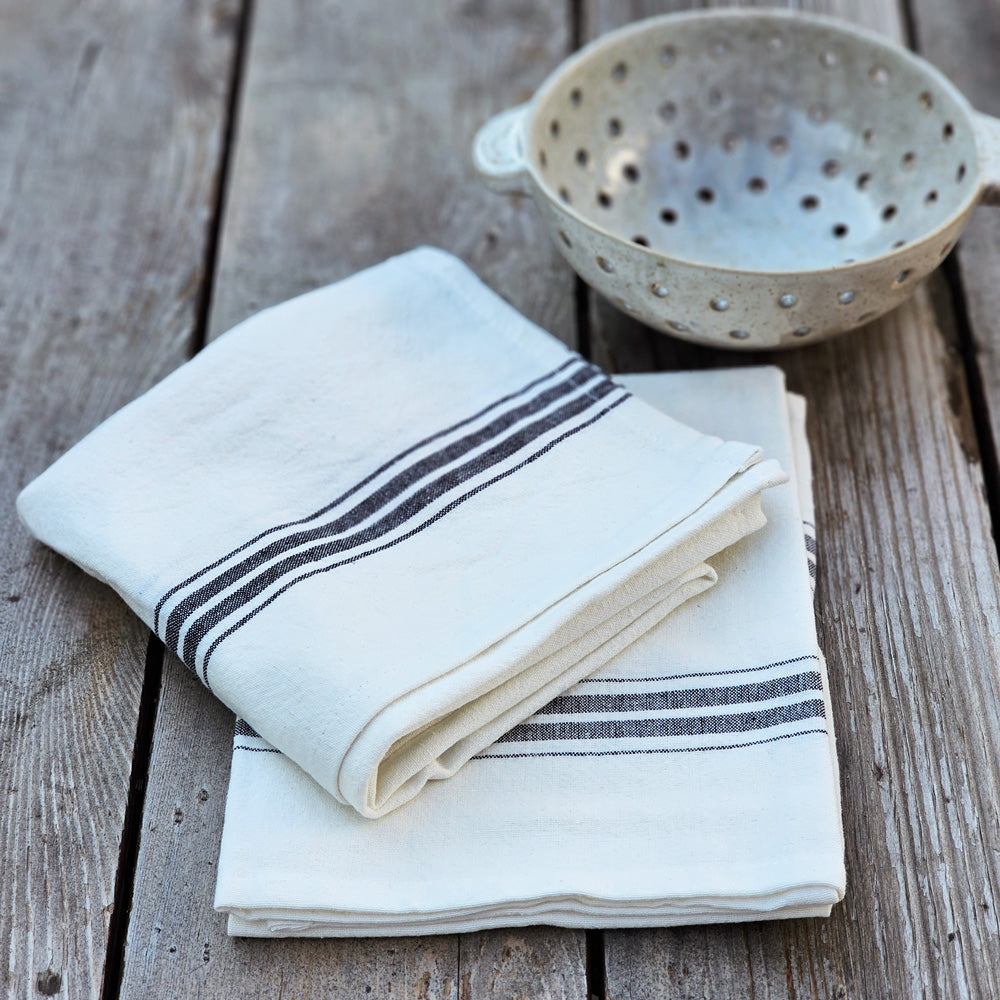 You'll love the French Country look of these Bistro Style Black Stripe Kitchen Towels. Classic black stripes against an ivory white background bring a bit of vintage style to your farm kitchen chores. The quality of this set's cotton makes for handy and easy care. Features loop on backside for hanging. Hand Wash. Set of 2, 100% cotton. 20" x 28"