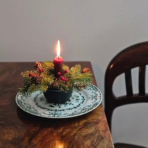 Add festive cheer to your taper candle with our Spruce and Berries Taper Candle Ring. This accent features a fresh collection of faux spruce peppered with sprigs of red berries and dashed with petite pine cones.Perfect for adding an earthy twist to taper candle holders and chandeliers, this ring provides a charming decorative accent all year long. Includes one ring. Candles and candle holders not included. 7” Diam with 2”inner