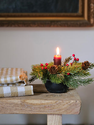 Add festive cheer to your taper candle with our Spruce and Berries Taper Candle Ring. This accent features a fresh collection of faux spruce peppered with sprigs of red berries and dashed with petite pine cones.Perfect for adding an earthy twist to taper candle holders and chandeliers, this ring provides a charming decorative accent all year long. Includes one ring. Candles and candle holders not included. 7” Diam with 2”inner