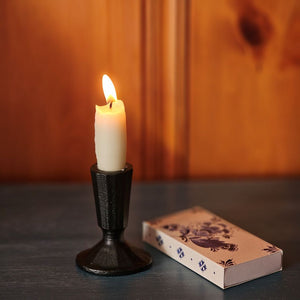 The understated elegance of our Blacksmith Taper Candle Holder lends an historic charm to any room. This artfully crafted black metal piece captures the essence of traditional metalwork with its hand-forged aesthetic, bringing timeless character to any space. The refined minimalist silhouette complements both contemporary and classic interiors, while its sturdy construction accommodates standard taper candles.