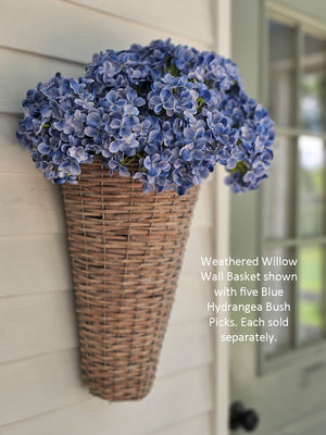 The Blue Hydrangea Bush Pick showcases exquisite blue fabric petals paired with fresh green leaves, creating a refined summer accent. Its flexible plastic stem supports bright hydrangea blooms subtly touched with soft white hues, adding depth and elegance. Measuring 17” long by 10” wide and 5” deep, this floral pick brings a sophisticated touch to any arrangement or decor.