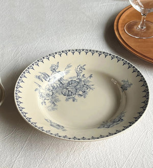 Inspired by antique transferware, our Blue Leaf Transferware Soup Bowl lends French country cottage style to any shelf, tabletop or dinnerware collection. A vintage classic, transferware has adorned the shelves of American farmhouses for centuries. The delicate floral pattern in vintage blue on an antique white background. Perfect for soups and salads. Food safe. Hand wash recommended. Includes one bowl. 8.96" Diam
