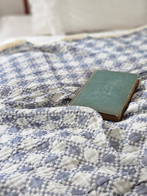 This Blue Quilt-Inspired Diamond Pattern Throw Blanket is the perfect addition to any American farmhouse-inspired decor. It features a striking sky blue and cream diamond pattern that is reminiscent of old quilts and is made from a lightweight, triple-weave cotton fabric. It also has a fringed edge for an extra touch of charm. Please note: this is not a quilt, but light, gossamer weave throw. 100% Cotton. Machine wash. 50" x 70"