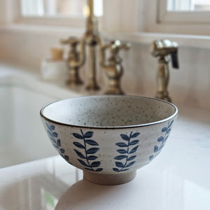 Experience the rustic charm of the Blue Vine Stoneware Bowl Set. Hand-painted with a reactive glaze, each bowl boasts a unique color, texture, and finish. Use them to serve dips, soups, snacks, and more. The organic shapes and earthy tones add a touch of nature to your table. Crafted with sturdy stoneware, these bowls are perfect for everyday use. Microwave and dishwasher safe. Set of four. Each bowl is 6.3" Diam x 3.3"H