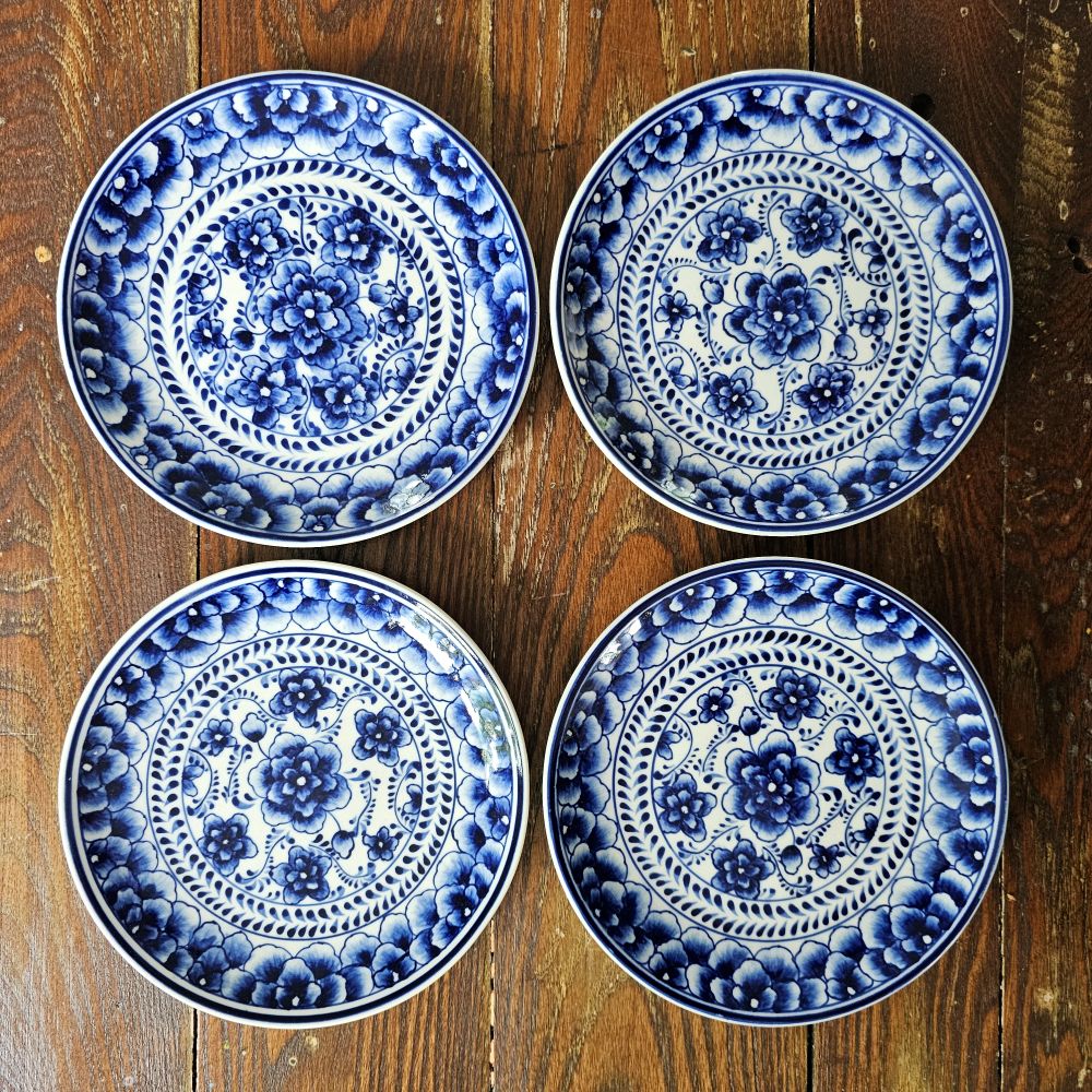 Our Blue and White Floral Plate Set embodies vintage charm, meticulously hand-crafted from natural ceramic. These exquisite appetizer plates, adorned with delicate indigo floral patterns on an antique white base, are ideal for serving desserts and small bites. Designed for everyday use, they are both microwave and dishwasher safe. The set includes four plates, each measuring 6 1/2 inches in diameter. Set of 4