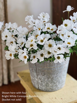 You know summer is in full swing when the coreopsis is in bloom. These daisy-like blossoms create a relaxed wildflower style bouquet, as if they have just been plucked from a countryside meadow.  This sweet Bright White Coreopsis Bouquet is lush with flowers. It features approximately 16 stems and 20 faux bright white flowers and green leaves. This Bright White Coreopsis Bouquet measures approximately 11”W x 21”H