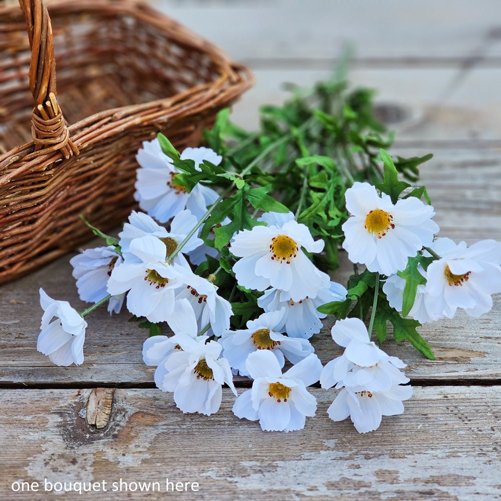 You know summer is in full swing when the coreopsis is in bloom. These daisy-like blossoms create a relaxed wildflower style bouquet, as if they have just been plucked from a countryside meadow.  This sweet Bright White Coreopsis Bouquet is lush with flowers. It features approximately 16 stems and 20 faux bright white flowers and green leaves. This Bright White Coreopsis Bouquet measures approximately 11”W x 21”H