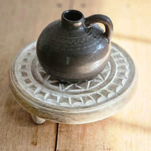 Just like old jugs from colonial times this Brown Porcelain Mini Jug offers rustic charm with its simple design. This decorative pottery jug has a smooth, shiny dark gray-brown glaze. The jug has a narrowed opening and is finished with a small, rounded handle at the top. 