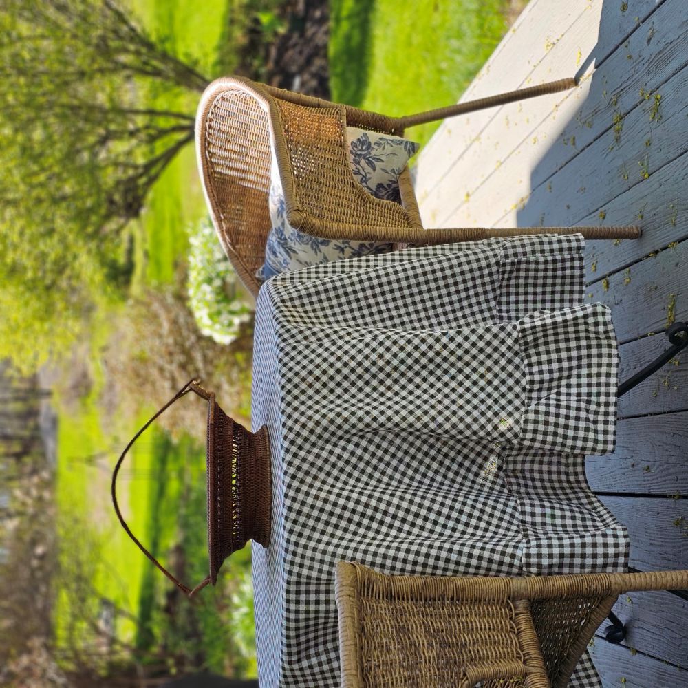 Enhance any occasion with the Brown and White Gingham Check Tablecloth with Ruffled Edge, where timeless country charm meets refined design. This durable and easy-care tablecloth sets the scene for countryside gatherings. The classic gingham pattern combined with the ruffled edge creates a sweet, vintage look no matter the season. Cotton/polyester blend. Available in two sizes: 72" Round and 56" x 120" Rectangle