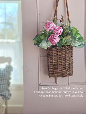 Hanging basket with pink cabbage roses and cabbage head picks.