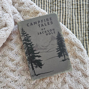 Inspired by antique bookshop finds, our Hardcover Book Journal, Campfire Tales is like snuggling up with an old book, only this time, you get to be the author. Features a faded hardcover and discolored paper pages. It's infused with vintage charm. Like old books, the pages of this journal have an aged warmth and have lines for neat note keeping. The binding also has an old book feel and the cover features a vintage graphic with the title, "Campfire Tales." 5.75"L x 1.25"Deep X 8.5"H