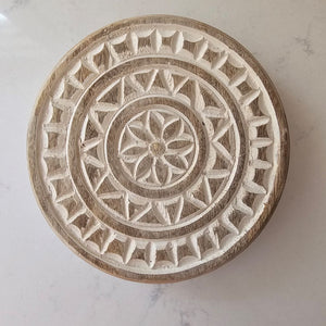 This Round Carved Wood Riser makes a beautiful accent piece for any home. With its whitewash finish and carved design, it's both stylish and functional. An updated take on vintage bread boards, this footed riser can be used both decoratively, as a trivet and for displaying items. 7" diam x 1.25"H