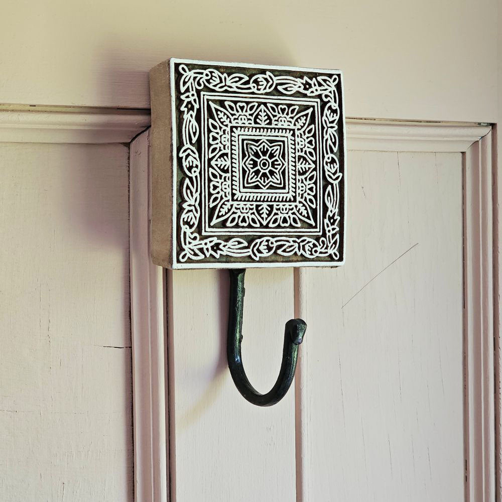 Embrace the charm of the old-world crafts with our Carved Wood Print Block Hook. This wall hook repurposes the intricately carved vintage printing blocks, traditionally used to create beautiful fabrics. Perfect for hanging jewelry, hats, towels, or utensils, this hook adds a touch of functional elegance to any space. Each hook tells its own unique story through imperfections that are celebrated as part of its history and character. Elevate your decor with these vintage-inspired pieces that seamlessly blend 