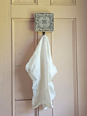 Embrace the charm of the old-world crafts with our Carved Wood Print Block Hook. This wall hook repurposes the intricately carved vintage printing blocks, traditionally used to create beautiful fabrics. Perfect for hanging jewelry, hats, towels, or utensils, this hook adds a touch of functional elegance to any space. Each hook tells its own unique story through imperfections that are celebrated as part of its history and character. Elevate your decor with these vintage-inspired pieces that seamlessly blend 