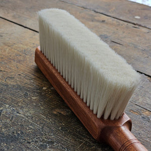 The Cashmere Wood Handled Cleaning Brush is perfect for removing dust and debris from sensitive fabrics or delicate objects. Made of 70% cashmere/wool this brush is plush and super soft with a vintage style wood handle and leather loop for hanging. Ideal for use on silk, wool, velvet, and other fine textiles as well as delicate objects such as keyboards. 