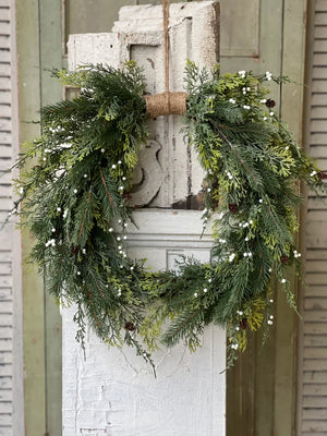 The White Berry and Cedar Wreath brings a quiet elegance to any room. Beautiful mixed greenery is interspersed with constellations of small white orbs and pine cones to create a collection perfect for season-long use. The twine wrap along the top adds a down-to-earth, rustic touch. 24"