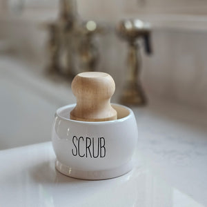 Keep your dish scrub brush neatly organized with our Ceramic Scrub Brush Holder with Brush. Made of crisp white ceramic with black embossed lettering, this holder not only adds a touch of style to your sink, but also keeps your brush within reach for quick and easy cleaning. Say goodbye to cluttered counters and hello to a convenient sink-side solution. Comes with one wood dish scrub brush. Holder is 3.25" diam x 2.25"H, Brush is 2.25" diam x 3.25"H